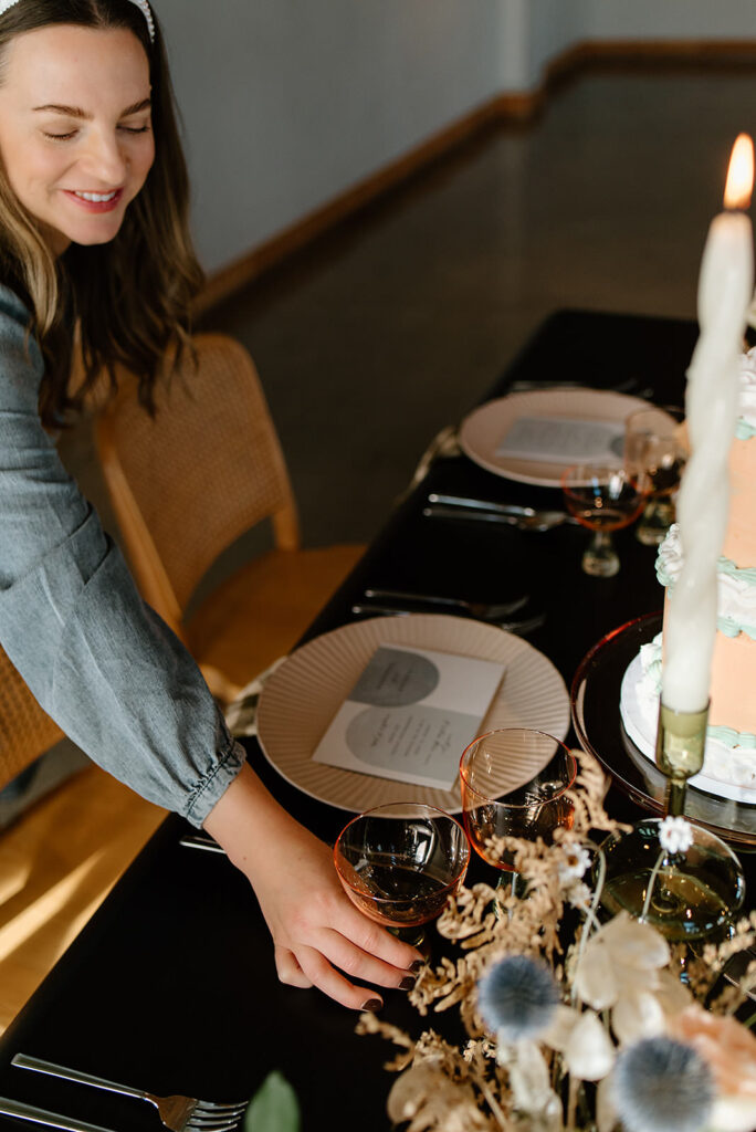 Meghan, from Sideways and Co., setting a glass down on the table
